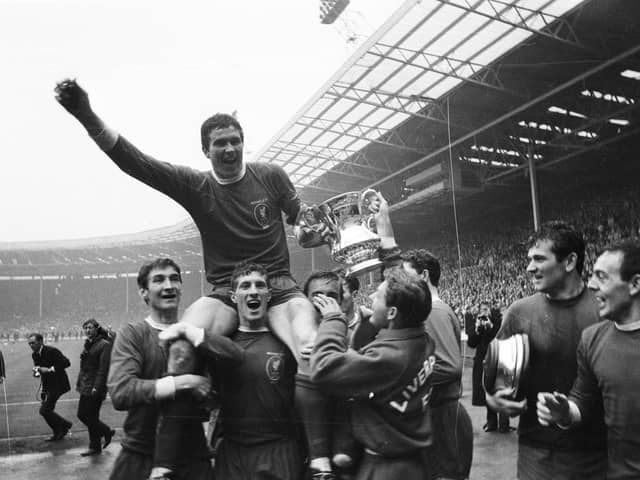 Captain of Liverpool FC, Ron Yeats holds the FA cup as he is chaired by fellow members of the victorious team. (Photo by Larry Ellis/Express/Getty Images)