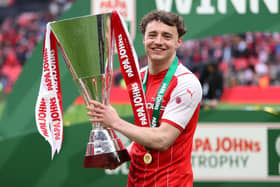 PIZZA SILVERWARE: Rotherham United's Oli Rathbone celebrates with the EFL Trophy in a previous incarnation