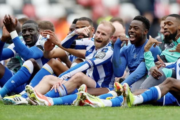 ELATION: Sheffield Wednesday players celebrate in front of the away fans at full-time with captain Barry Bannan at the centre of it all