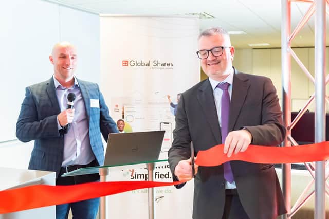 Councillor James Lewis (right) and Darren Smith of Global Shares (left) cut the ribbon on the new office. Picture: Jonathan Pow/jp@jonathanpow.com