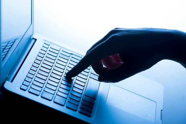 A woman's hand pressing a key of a laptop keyboard. PIC: Dominic Lipinski/PA Wire