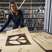 Bradford University archivist Julie Parry with prototype sketches of the Campaign for Nuclear Disarmament's (CND) iconic peace symbol made in 1958 by artist Gerald Holtom. The drawings were later bequeathed by his widow to the Commonweal (CORR) Collection, a peace-themed library of more than 4,000 books within the JB Priestley Library at Bradford University, whose Peace Studies department  celebrates its 50th anniversary this year.Writing in the New Statesman on 2 November 1957, Bradford-born Priestley argued Britain should renounce nuclear weapons. The article generated a huge response, culminating in the launch of the Campaign for Nuclear Disarmament at a mass meeting in Central Hall Westminster on 17 February 1957. Image: Asadour Guzelian