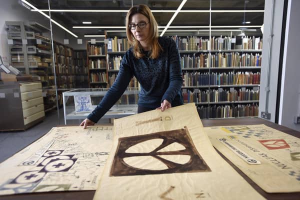 Bradford University archivist Julie Parry with prototype sketches of the Campaign for Nuclear Disarmament's (CND) iconic peace symbol made in 1958 by artist Gerald Holtom. The drawings were later bequeathed by his widow to the Commonweal (CORR) Collection, a peace-themed library of more than 4,000 books within the JB Priestley Library at Bradford University, whose Peace Studies department  celebrates its 50th anniversary this year.Writing in the New Statesman on 2 November 1957, Bradford-born Priestley argued Britain should renounce nuclear weapons. The article generated a huge response, culminating in the launch of the Campaign for Nuclear Disarmament at a mass meeting in Central Hall Westminster on 17 February 1957. Image: Asadour Guzelian