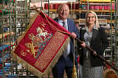 The new hand crafted Blues and Royals sovereign standard bearing the insignia of King Charles III is displayed by Robin and Rosie Wright of Wyedean, before it leaves the firm’s factory in Haworth, West Yorkshire for Saturday’s Trooping of the Colour. Lorne Campbell/Guzelian