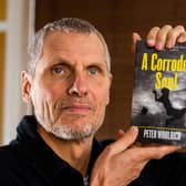 Peter Woolrich with his debut book A Corroded Soul.