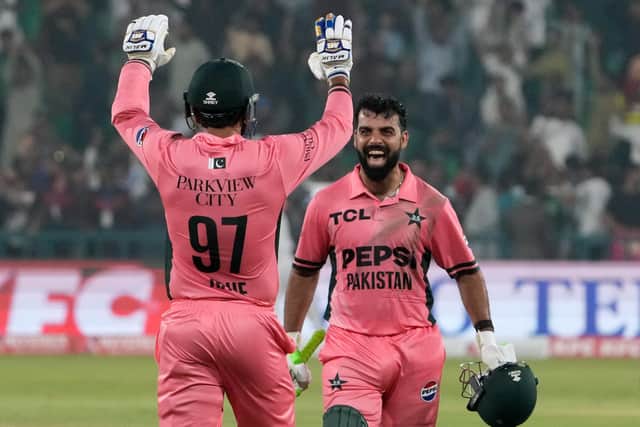 Shadab, right, and Haris Rauf celebrate victory over England. Photo: AP Photo/K.M. Chaudary