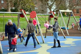 A stock photo of children in a playground with parents. PIC: Alamy/PA
