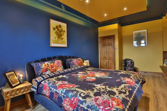 The Van Gogh inspired room, the master bedroom with ensuite, with prints of Sunflowers and Irises, and Little Greene’s Deep Space Blue and Yellow Pink for the walls. Picture by Charlotte Hedgecock