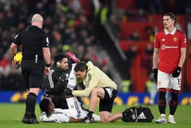 Leeds United's Colombian striker Luis Sinisterra receiving medical attention during the English Premier League football match between Manchester United and Leeds United at Old Trafford in Manchester, north west England, on February  8, 2023. (Photo by OLI SCARFF/AFP via Getty Images)
