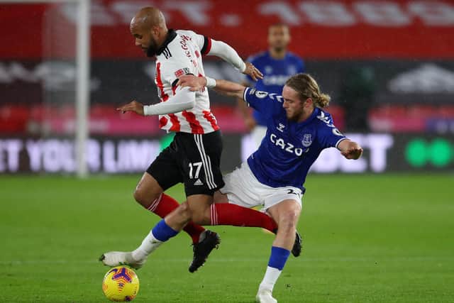 DIFFERENT SIDES: Tom Davies, tussles with Sheffield United's David McGoldrick while playing for Everton during a Premier League match at Bramall Lane in December 2020 Picture: Simon Bellis/Sportimage