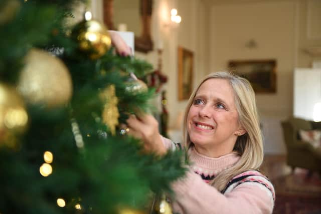 Clare Oglesby with one of Christmas trees she has decorated