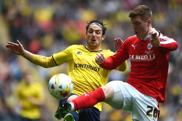 LONDON, ENGLAND - APRIL 03: Danny Hylton of Oxford United and Alfie Mawson of Barnsley in action during the Johnstone's Paint Trophy Final match between Oxford United and Barnsley at Wembley Stadium on April 3, 2016 in London, England. (Photo by Tom Dulat/Getty Images).
