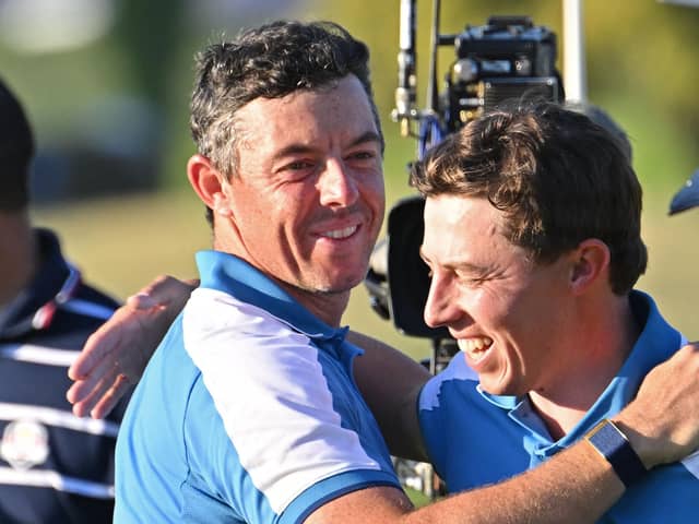Europe's English golfer, Matt Fitzpatrick (R) and Europe's Northern Irish golfer, Rory McIlroy (L) celebrate their four-ball match win on the first day of play in the 44th Ryder Cup at the Marco Simone Golf and Country Club in Rome (Picture: ALBERTO PIZZOLI/AFP via Getty Images)