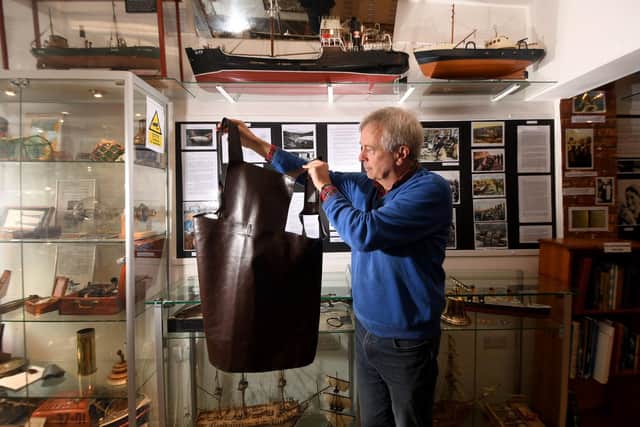 Local historian Stewart MacDonald is pictured in the exhibition holding an apron that the Herring Girls would have worn. Picture taken by Yorkshire Post Photographer Simon Hulme