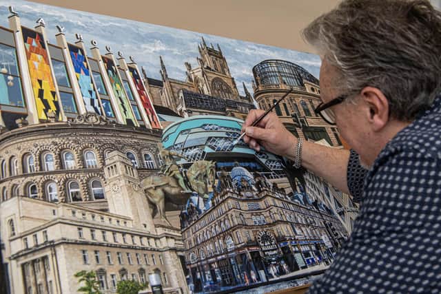 Alan Rogan works on his tribute to Leeds buildings. Picture by Tony Johnson.