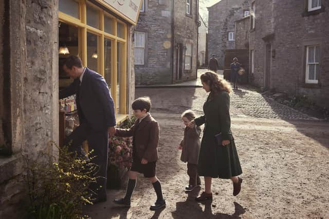 Shopping in Darrowby: Nicholas Ralph (James Herriot) Rachel Shenton (Helen Herriot) Thomas Riches (Jimmy Herriot) Isabella Ward (Rosie Herriot) ©5 Broadcasting Limited / © Playground Television UK Ltd. 2026 / Photographer: Helen Williams