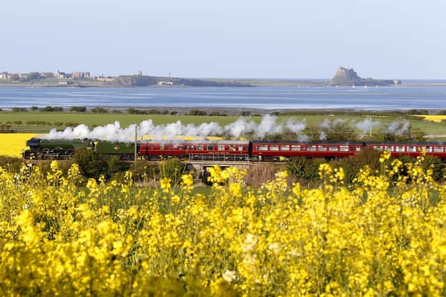 The Flying Scotsman passes Holy Island as it powers through the Northumberland countryside.