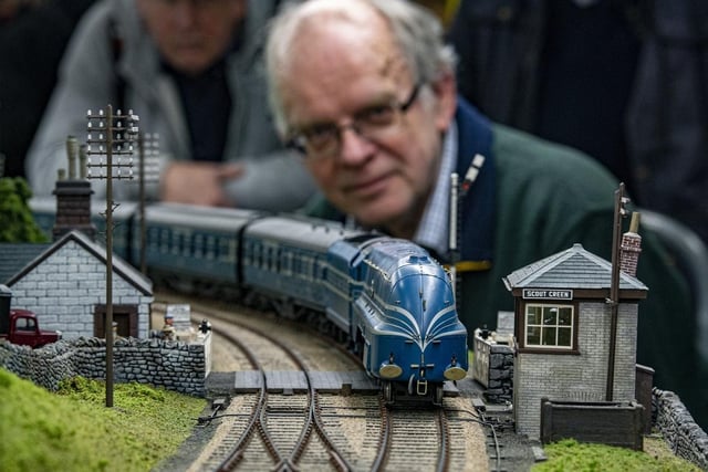 Kevin Day from the Sheffield O Gauge group keeps a close eye on Carnation Scot on the layout at Scout Green between Crewe and Carlisle on the London Midlands Scotland Railway.
