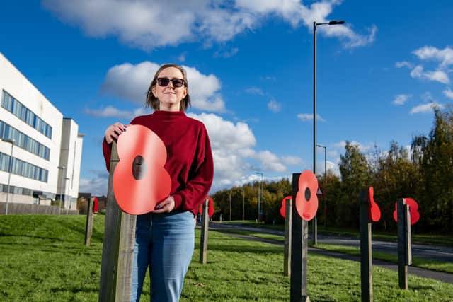 Emily Charlesworth from the Manvers Residents Association with poppies put out along Manvers Way in Manvers for Remembrance Sunday, photographed for The Yorkshire Post by Tony Johnson