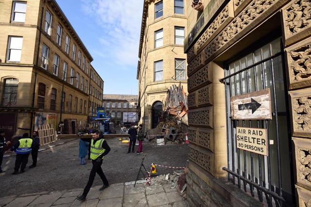 A sign points to an air raid shelter as Bradford's Little Germany area of former textile warehouses is transformed into bomb-hit 1940s Birmingham streets in preparation for tomorrow's filming. Picture by Asadour Guzelian
