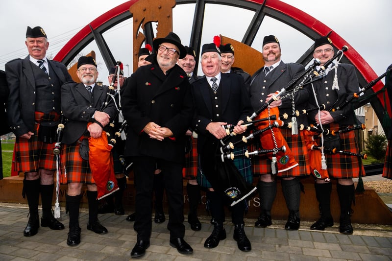 George Galloway, MP for Rochdale who attended the parade stands with members of the Pipe Bands who played at this special anniversary. Picture By Yorkshire Post Photographer,  James Hardisty. Date: 9th March 2024.