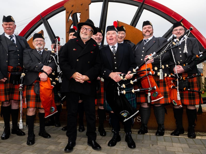 George Galloway, MP for Rochdale who attended the parade stands with members of the Pipe Bands who played at this special anniversary. Picture By Yorkshire Post Photographer,  James Hardisty. Date: 9th March 2024.