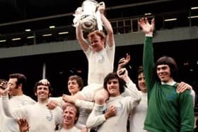 Billy Bremner holds aloft the FA Cup with his Leeds United team-mates after victory over Arsenal in May 1972.