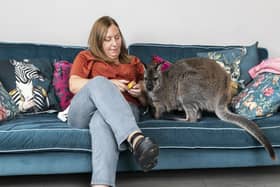 Hayley Bateman, 50, made the decision to take in Willow the wallaby and treat her just like a house pet, after her mother rejected her, pictured at their home in Hornsea