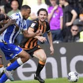Sheffield Wednesday's Akin Famewo burst past Hull City rivals Adama Traore and Lewie Coyle on Saturday. But it was a chastening afternoon for the defender and his Owls team-mates. Picture: Steve Ellis