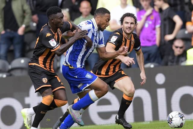 Sheffield Wednesday's Akin Famewo burst past Hull City rivals Adama Traore and Lewie Coyle on Saturday. But it was a chastening afternoon for the defender and his Owls team-mates. Picture: Steve Ellis