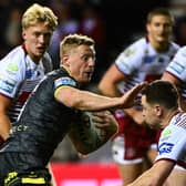 Lachie Miller bumps off Jai Field during Leeds' defeat at Wigan. (Photo: Olly Hassell/SWpix.com)