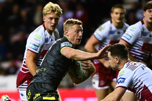 Lachie Miller bumps off Jai Field during Leeds' defeat at Wigan. (Photo: Olly Hassell/SWpix.com)