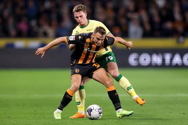 ALL SQUARE: Hull City's Scott Twine holds off Bristol City's George Tanner during last night's Championship clash at the MKM Stadium, the encounter ending in a 1-1 draw after a second-half equaliser from Nahki Wells for the visitors. Picture: George Wood/Getty Images