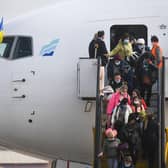 Ukrainian refugees disembark from an aircarft, chartered by the Portuguese NGO "Ukranian Refugees UAPT", after landing at Figo Maduro airport in Lisbon on March 10, 2022. (Photo by Patricia De Melo MOREIRA / AFP) (Photo by PATRICIA DE MELO MOREIRA/AFP via Getty Images)