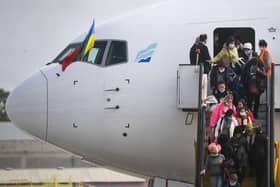 Ukrainian refugees disembark from an aircarft, chartered by the Portuguese NGO "Ukranian Refugees UAPT", after landing at Figo Maduro airport in Lisbon on March 10, 2022. (Photo by Patricia De Melo MOREIRA / AFP) (Photo by PATRICIA DE MELO MOREIRA/AFP via Getty Images)
