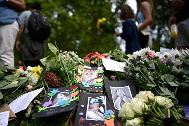 Floral tributes are seen left in Green Park in London on September 12 (Photo by LOIC VENANCE/AFP via Getty Images)