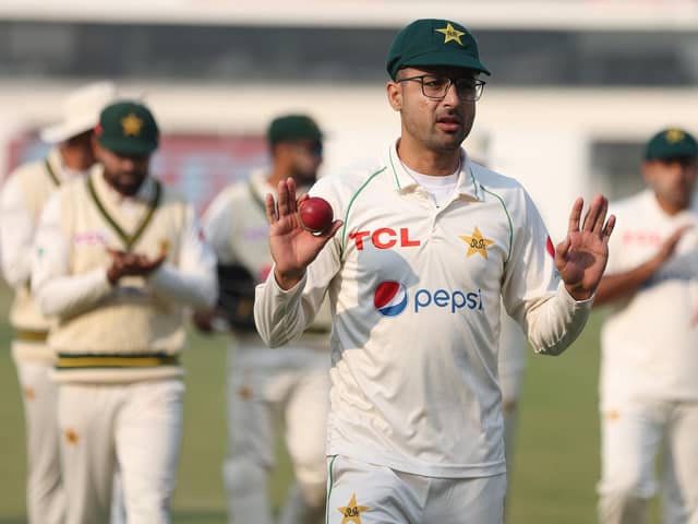 Abrar Ahmed of Pakistan is applauded by his team mates as he leaves the field after taking a seven-wicket haul against England in Multan. Photo by Matthew Lewis/Getty Images.