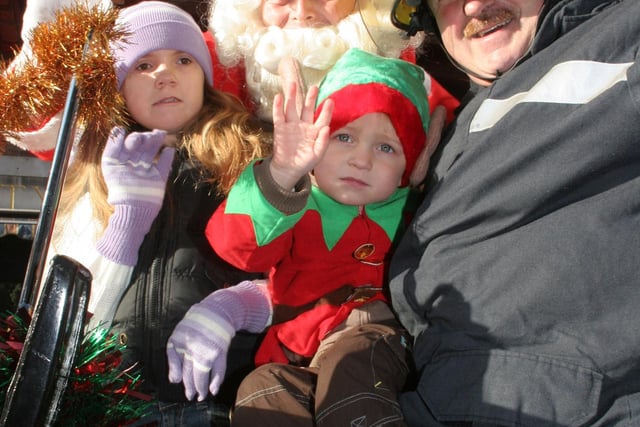 Maisie Lawrence aged 8 wth Santa, Owen Blake aged 3 and grandad fire fighter Owen Moran in 2006