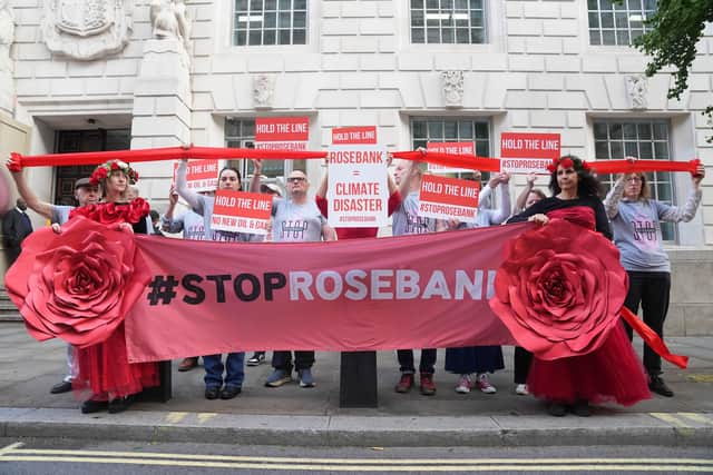 Organisers from Fossil Free London demonstrate using red ribbon to visually emphasise the Government's legally binding commitment to the Paris Climate Agreement, as a decision on Jackdaw and Rosebank oil fields is awaited, outside the Department For Energy Security And Net Zero in Whitehall, London. Picture date: Tuesday October 13, 2026. PA Photo. Photo credit should read: Maja Smiejkowska/PA Wire