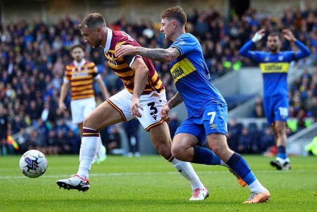 CHALLENGE: James Tilley tackles Bradford City's Liam Ridehalgh