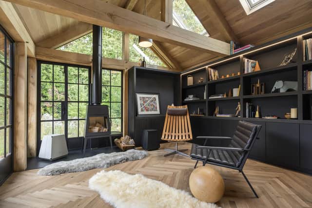 The garden room is filled with light and has plenty of space for books and a wood-burning stove