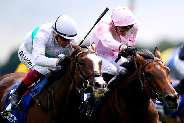 HOLDING ON: Warm Heart ridden by jockey James Doyle (right) on their way to winning the Yorkshire Oaks on day two of the Sky Bet Ebor Festival at York Racecourse. Picture: Mike Egerton/PA