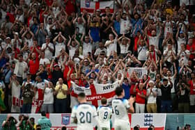 England players celebrate with supporters after they won the Qatar 2022 World Cup round of 16 football match between England and Senegal at the Al-Bayt Stadium in Al Khor.