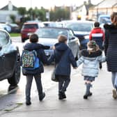 Parents walk their children to school. (Pic credit: Nick Ansell / PA Wire)