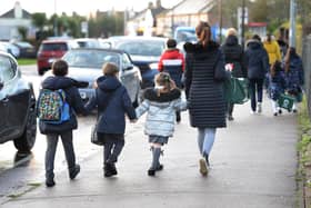 Parents walk their children to school. (Pic credit: Nick Ansell / PA Wire)