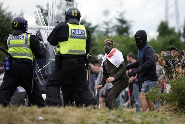 Riot police clash with anti-migration protesters outside of the Holiday Inn Express in Manvers on August 4, 2024 in Rotherham. (Photo by Christopher Furlong/Getty Images)