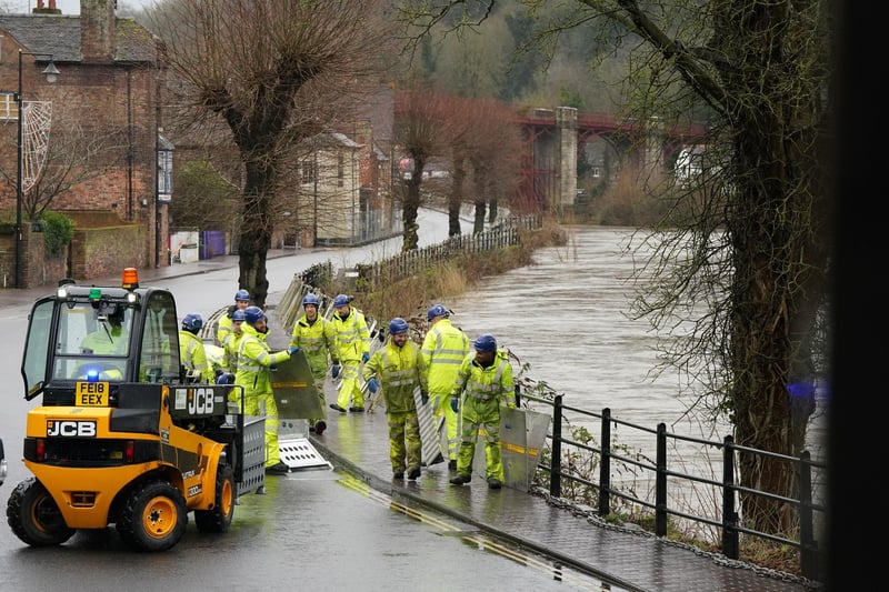 The swollen River Severn as flood defences are put in place along the wharfage at Ironbridge in Telford.