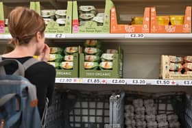 A customer looks at the price of eggs at the Tesco supermarket, in Aylesbury, England, on August 15, 2023. (Photo by JUSTIN TALLIS / AFP)