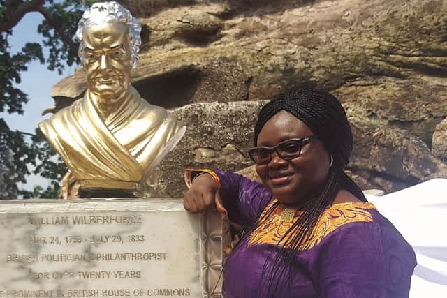A statue of Wilberforce in Wilberforce, Sierra Leone - pictured is Isatu Smith, a heritage consultant. (Pic credit: Isatu Smith)