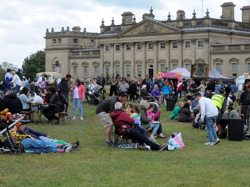 The Great British Food Festival. Visitors to the festival relax as they listen to the entertainment with Harewood House as a backdrop